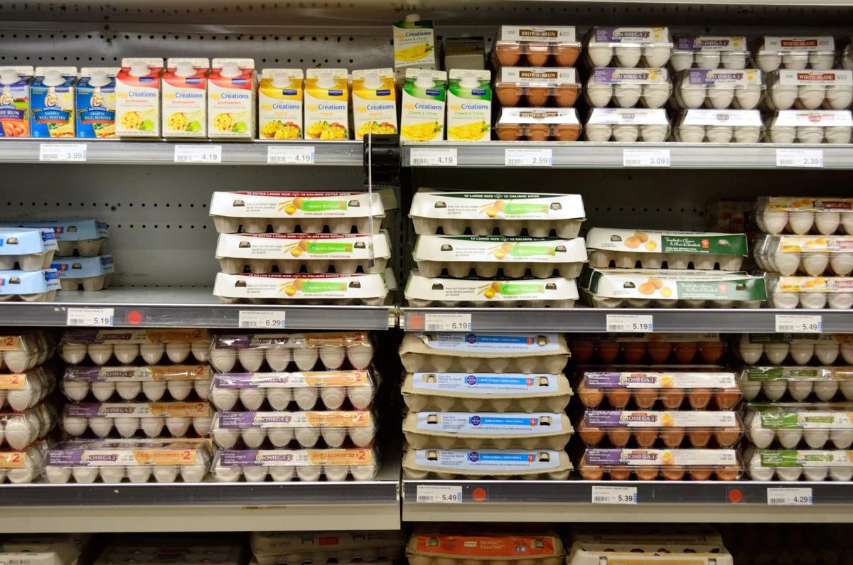 Egg cartons displayed in a grocery store refrigerated case